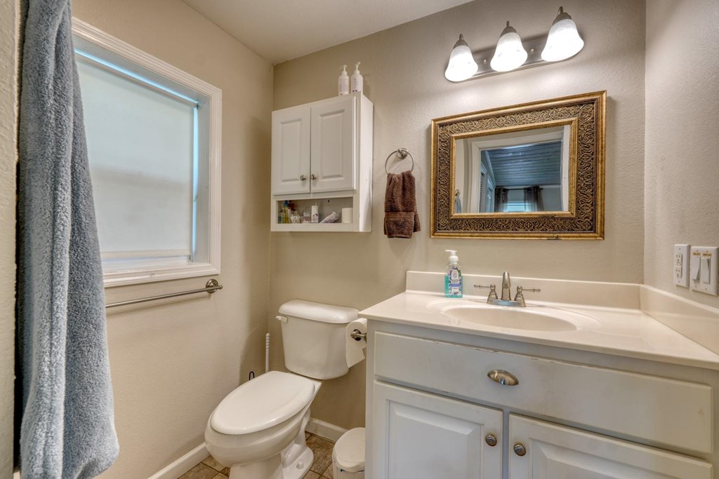 710 Town Mountain Road Hayesville, NC 28904 - Photo 48 of 68 a bathroom with a toilet a sink and mirror