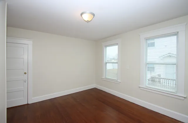 a view of a room with wooden floor
