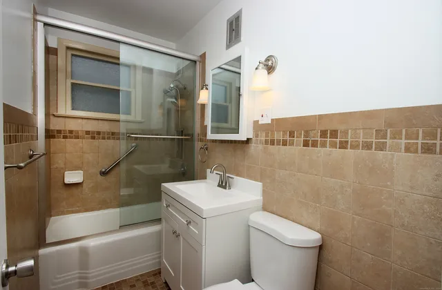 a bathroom with a toilet sink and mirror