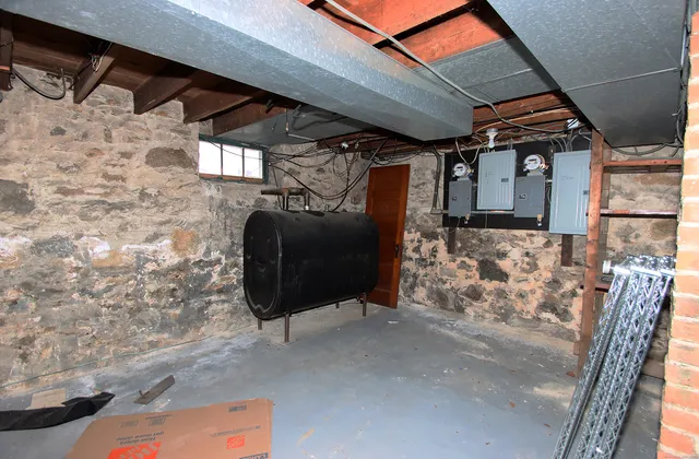 a view of a house with wooden fence and a bench