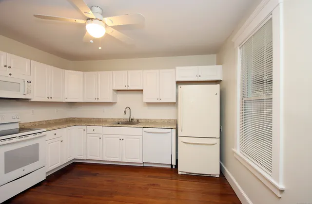 a kitchen with a refrigerator a sink and cabinets