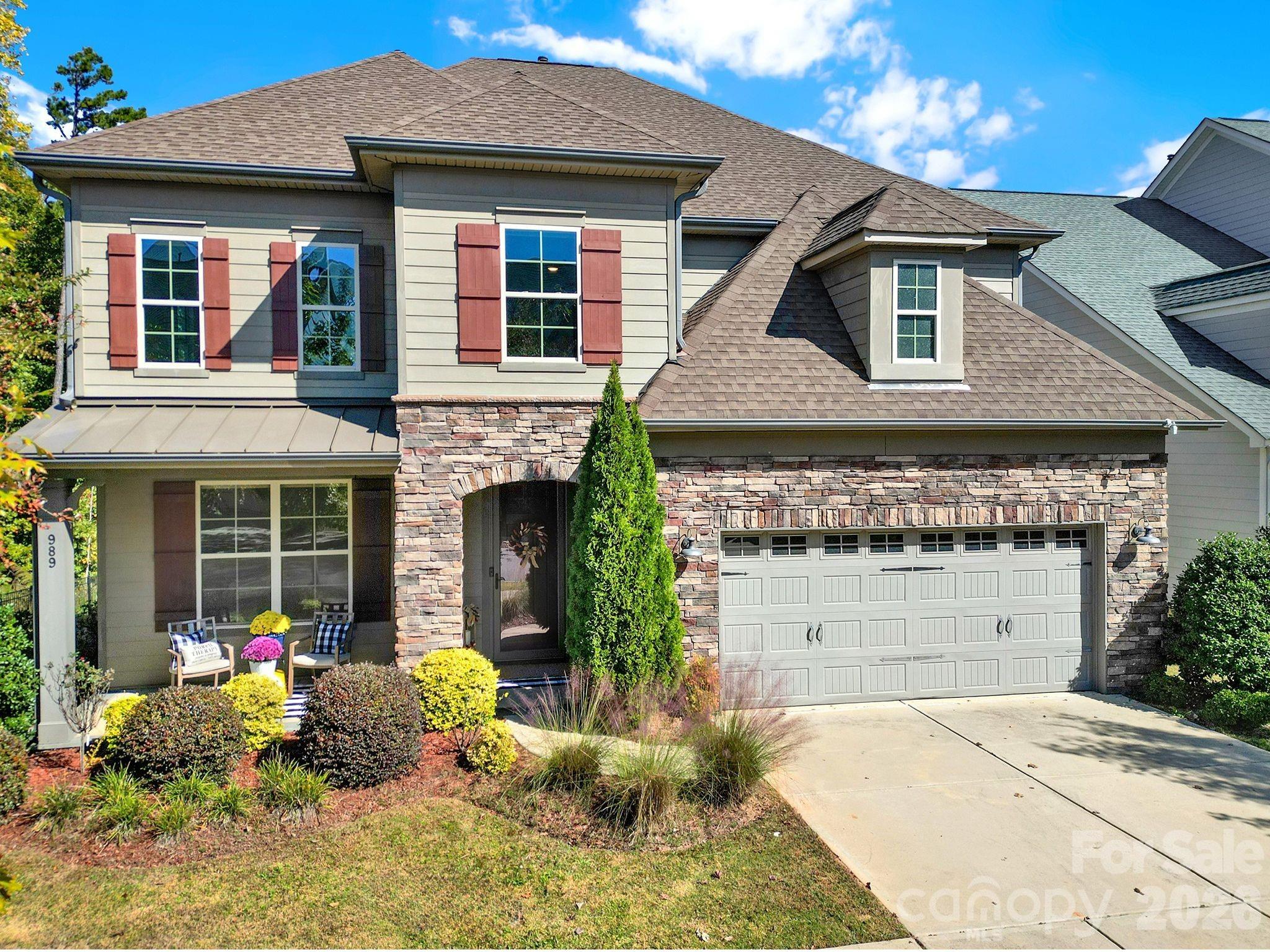 989 Emory Lane Fort Mill, SC 29708 - Photo 1 of 48 a front view of a house with a yard and potted plants
