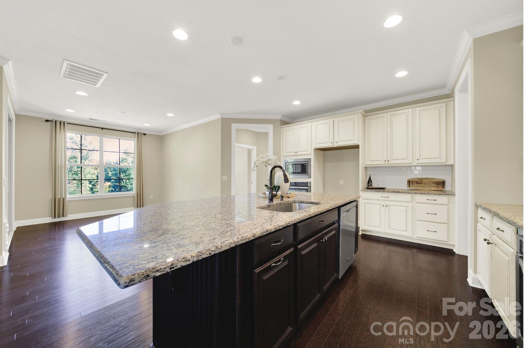 989 Emory Lane Fort Mill, SC 29708 - Photo 11 of 48 a kitchen with granite countertop a sink stove and cabinets