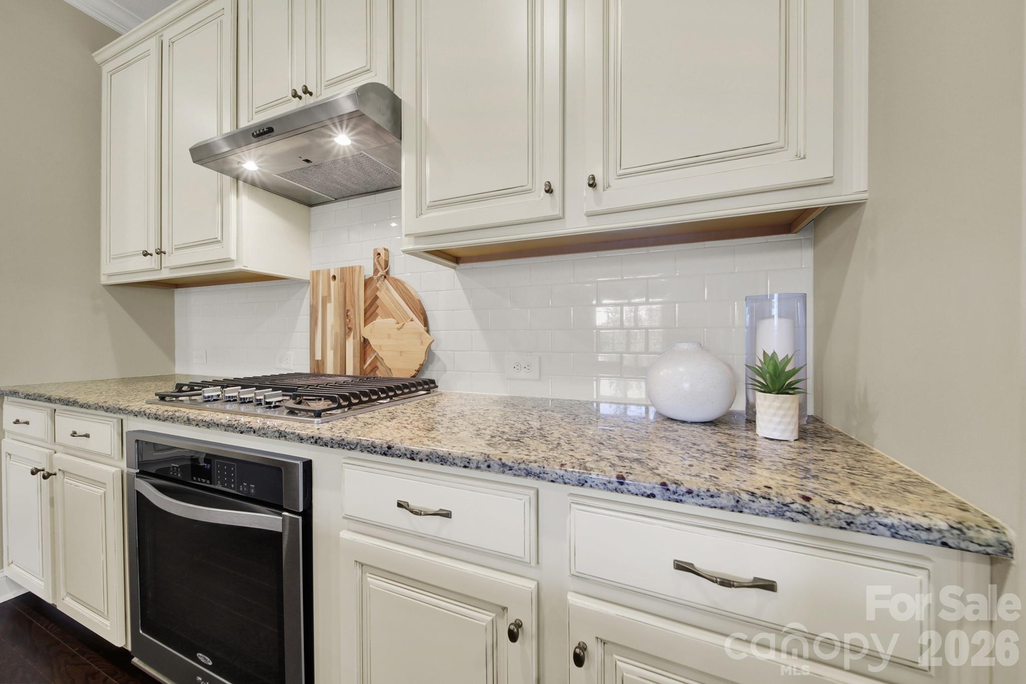 989 Emory Lane Fort Mill, SC 29708 - Photo 12 of 48 a kitchen with granite countertop white cabinets and a stove