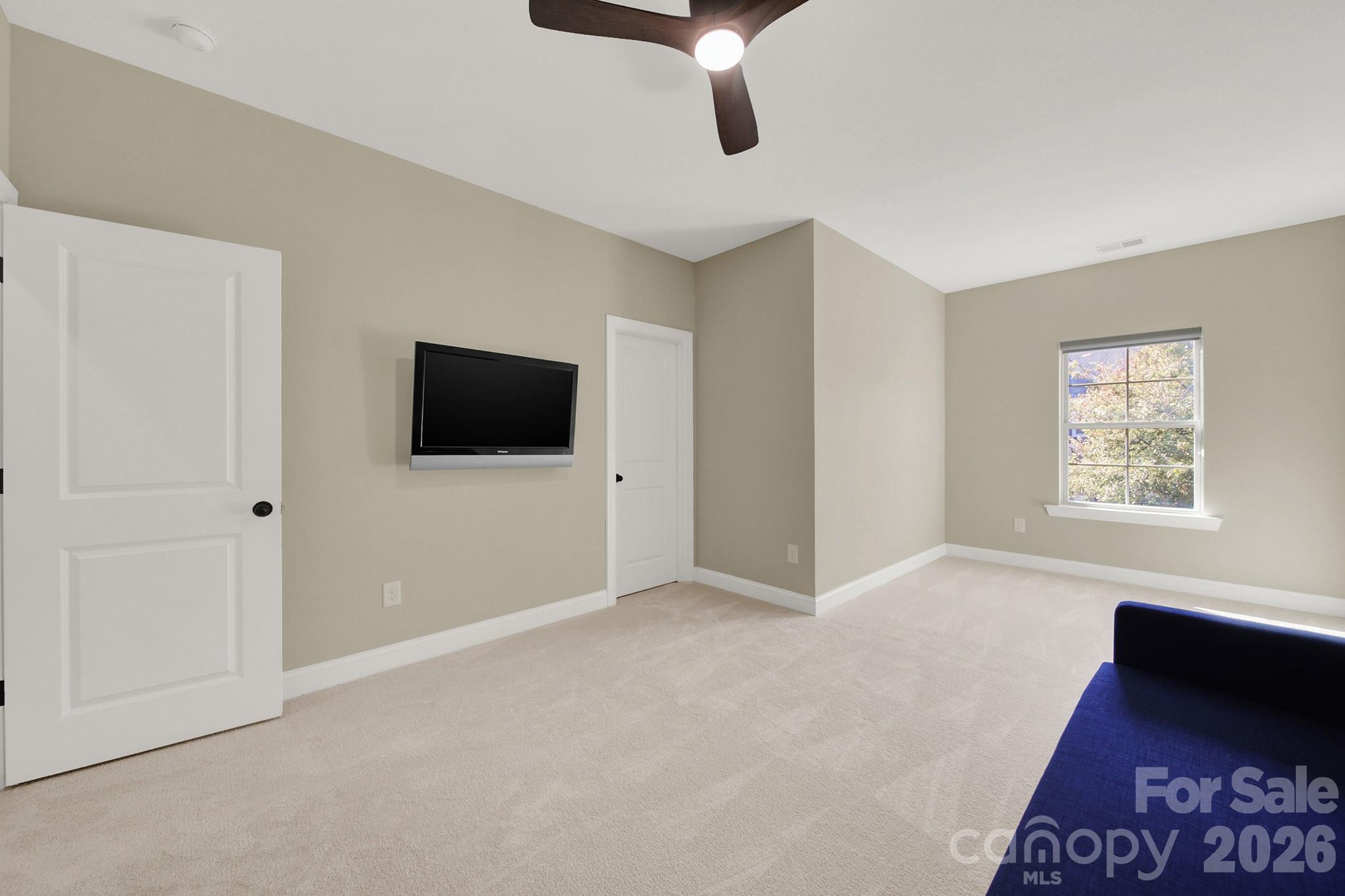 989 Emory Lane Fort Mill, SC 29708 - Photo 32 of 48 a view of an empty room with a window and a flat screen tv