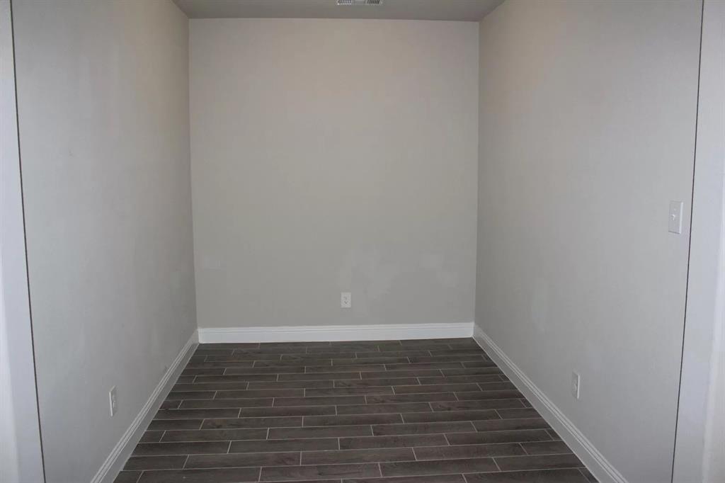 1752 Redding Street Allen, TX 75002 - Photo 16 of 24 Unfurnished room with dark wood-type flooring