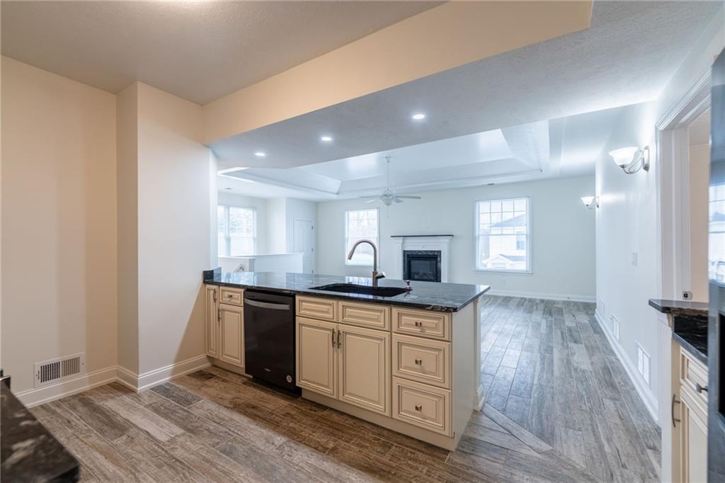 234 Adams Pointe Boulevard, Unit 2 Mars, PA 16046 - Photo 11 of 36 a view of a kitchen counter space with wooden floor and staircase