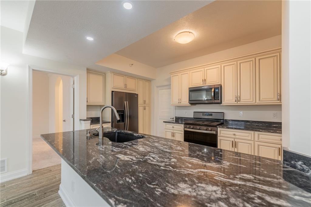 234 Adams Pointe Boulevard, Unit 2 Mars, PA 16046 - Photo 18 of 36 a kitchen with stainless steel appliances granite countertop a stove top oven a sink dishwasher and a refrigerator with wooden floor