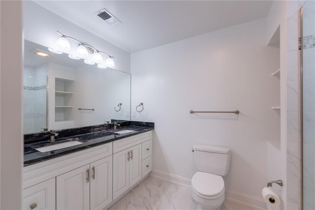 234 Adams Pointe Boulevard, Unit 2 Mars, PA 16046 - Photo 27 of 36 a bathroom with a granite countertop sink a toilet and mirror
