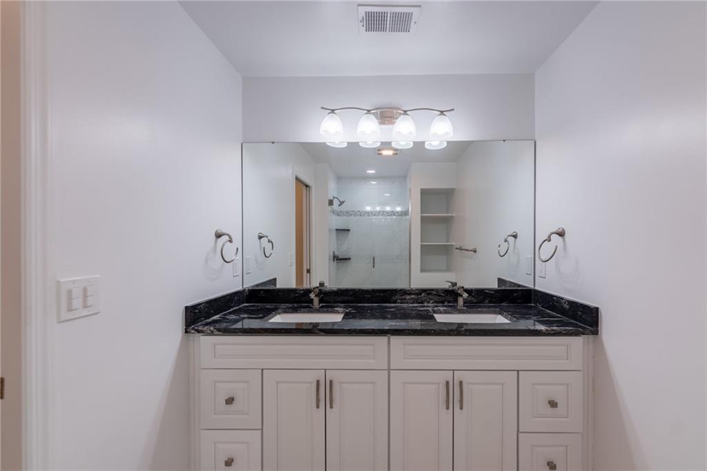 234 Adams Pointe Boulevard, Unit 2 Mars, PA 16046 - Photo 29 of 36 a bathroom with a granite countertop sink a vanity and a mirror
