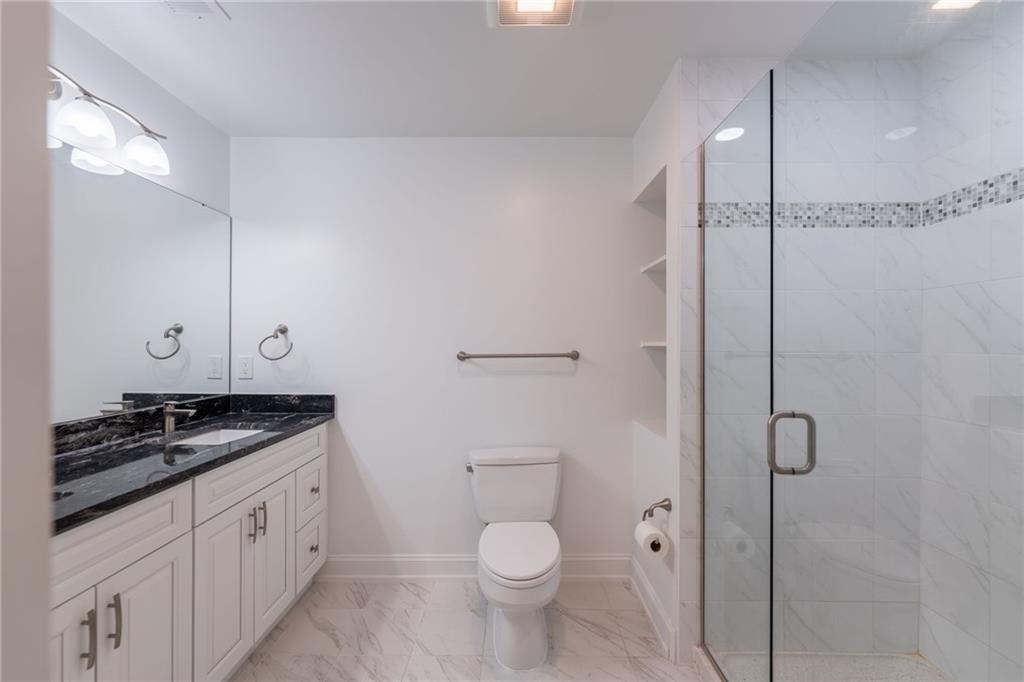 234 Adams Pointe Boulevard, Unit 2 Mars, PA 16046 - Photo 31 of 36 a bathroom with a granite countertop sink toilet and shower