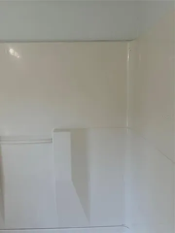 a kitchen with stainless steel appliances granite countertop a sink a stove a cabinets wooden floor and a window