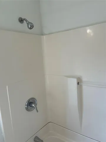 an empty room with wooden floor and door