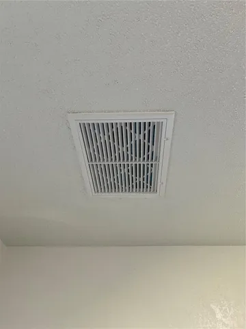 a view of a kitchen with a sink and a refrigerator