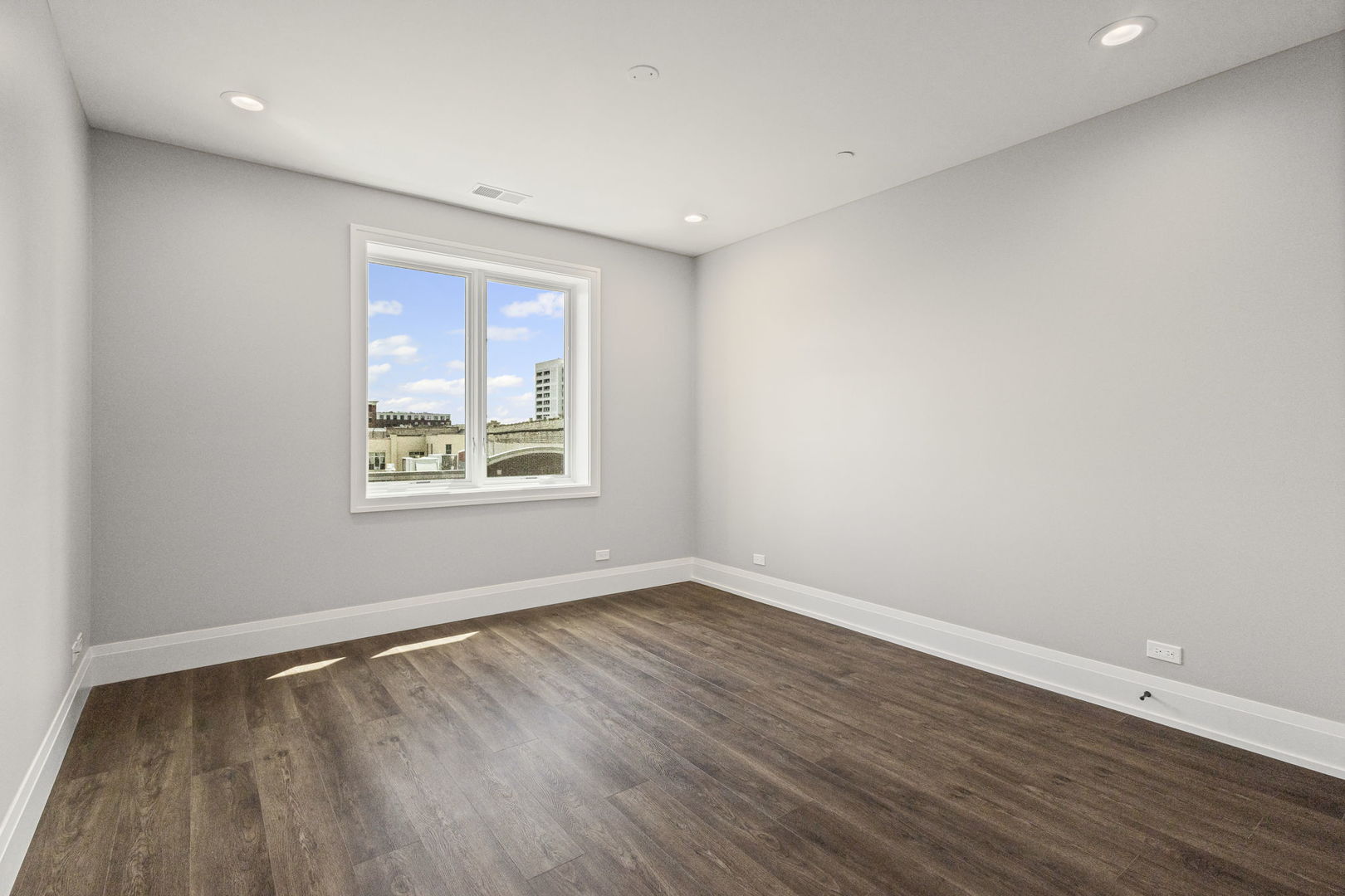1036 Lake Street, Unit 4S Oak Park, IL 60301 - Photo 15 of 29 a view of an empty room with wooden floor and a window