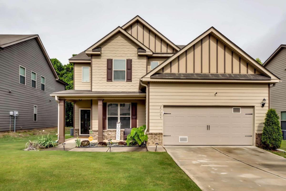 a view of a house with a yard and plants