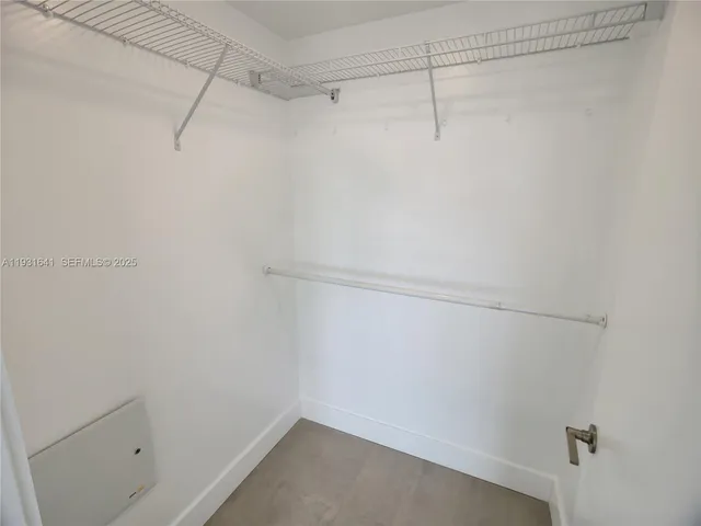 a bathroom with a granite countertop toilet and a sink