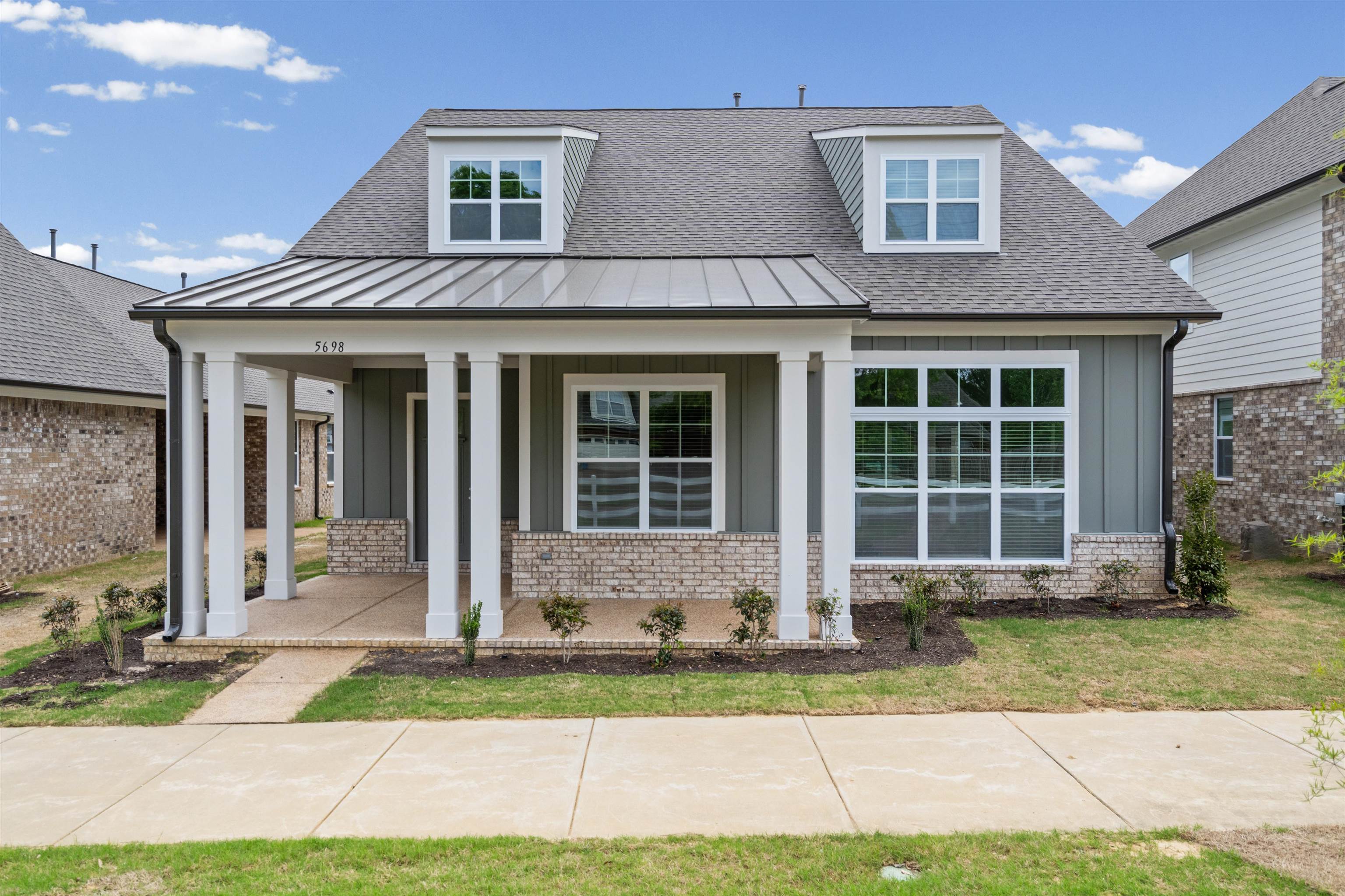 5698 Gerber Road Arlington, TN 38002 - Photo 1 of 29 View of front of house with a porch, brick siding, a shingled roof, board and batten siding, and a standing seam roof