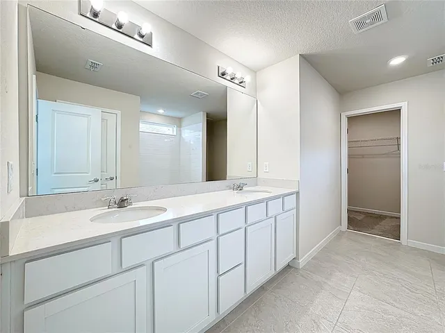a spacious bathroom with a double vanity sink mirror and