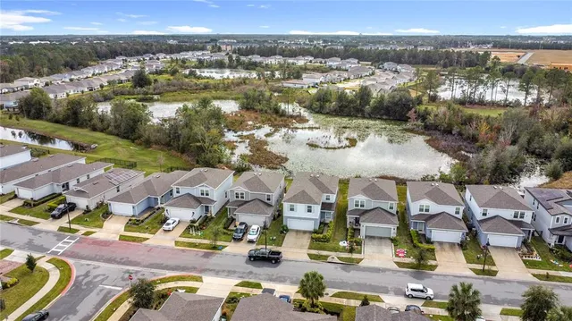 an aerial view of residential houses with outdoor space