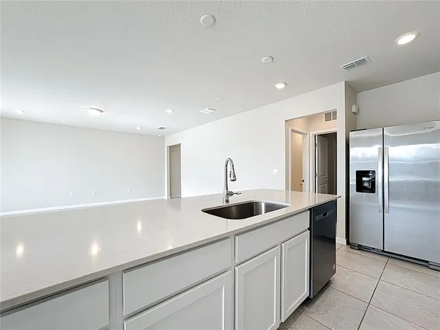 a kitchen with a sink and refrigerator