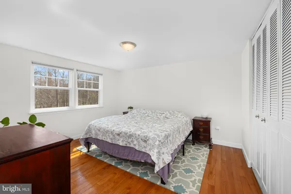 a bedroom with a bed and windows