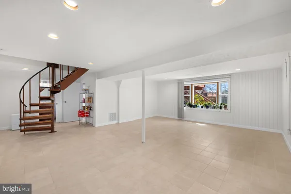 an empty room with stairs and white equipment