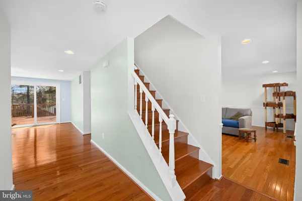 a view of entryway and hall with wooden floor