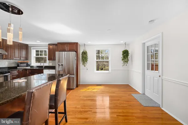 a kitchen with stainless steel appliances granite countertop a refrigerator a stove top oven a sink and dishwasher