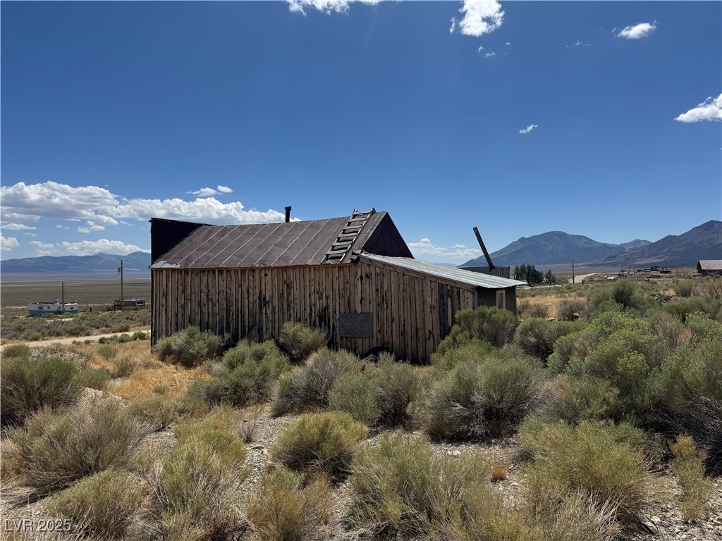 25 North Main Street Ely, NV 89301 - Photo 16 of 38 View of home's exterior featuring a mountain view and an outbuilding