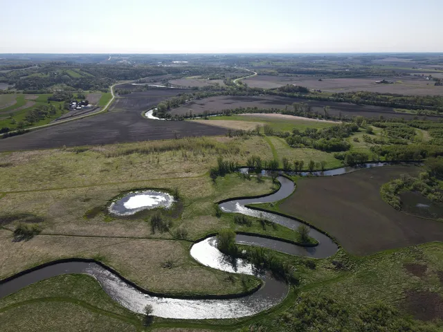 an aerial view of a houses with beach