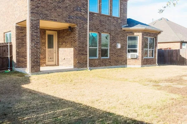 a view of a brick house with a outdoor space