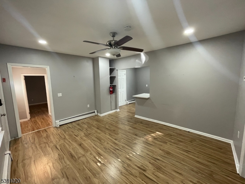 31 Union Street Dover, NJ 07801 - Photo 4 of 15 wooden floor in an empty room with a window