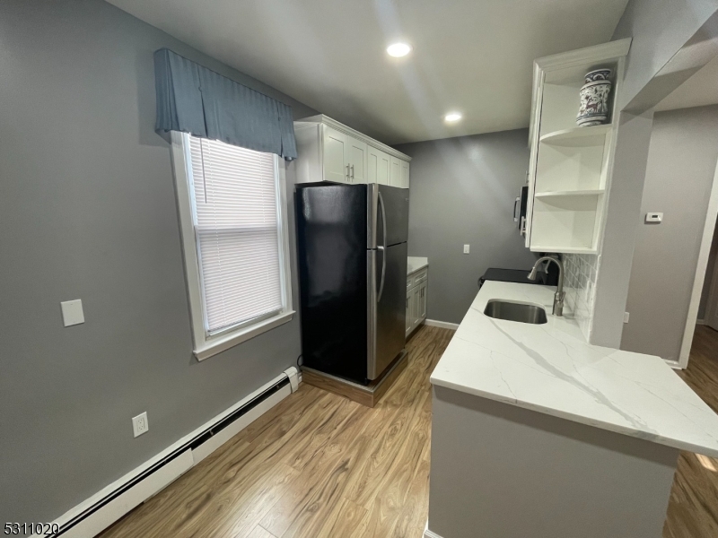 31 Union Street Dover, NJ 07801 - Photo 6 of 15 a room with a refrigerator and a window