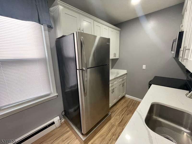 31 Union Street Dover, NJ 07801 - Photo 9 of 15 a kitchen with a refrigerator and a window
