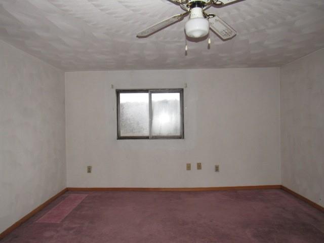 358 Ferguson Road Dunbar, PA 15431 - Photo 11 of 32 an empty room with a chandelier fan and wooden floor