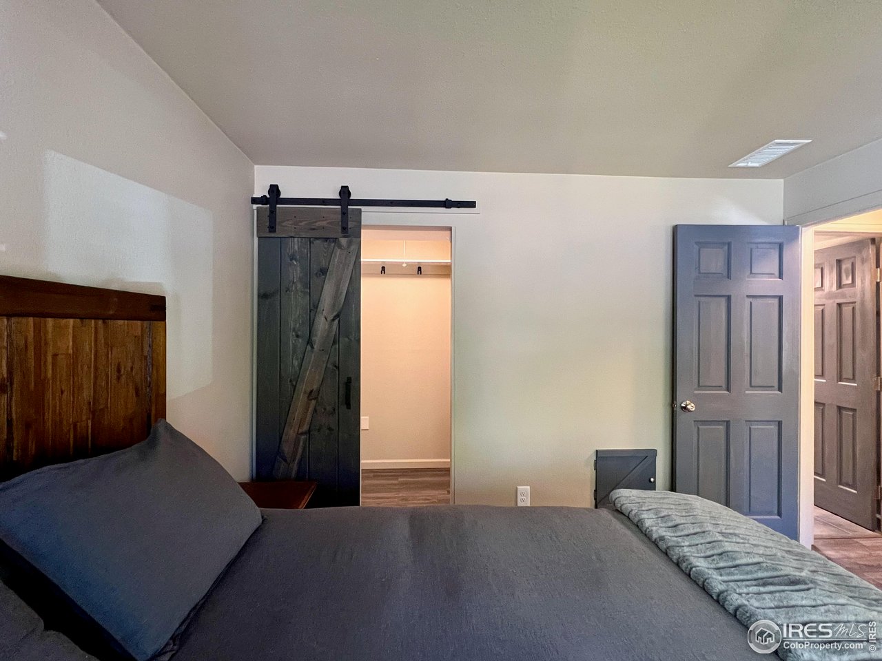 1705 Heatheridge Road, Unit 204 Fort Collins, CO 80526 - Photo 17 of 32 Bedroom with Walk-in Closet with Barn Door
