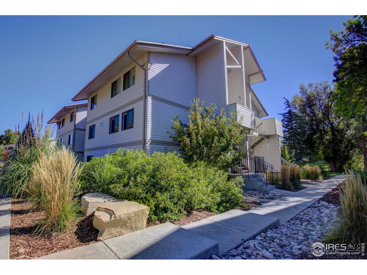 1705 Heatheridge Road, Unit 204 Fort Collins, CO 80526 - Photo 2 of 32 Exterior Bldg M features nicely maintained landscaping