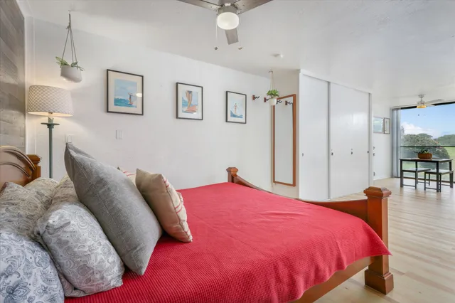 a bedroom with a bed a table and chair