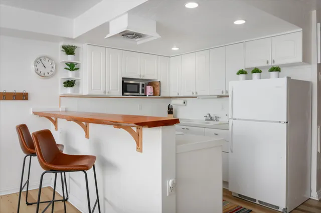 a kitchen with a refrigerator and a table