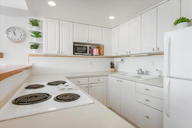 a kitchen with a cabinets and a stove top oven