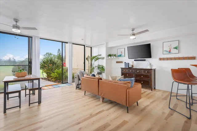 a living room with furniture and a flat screen tv