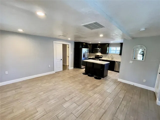 a kitchen with stainless steel appliances a refrigerator sink and cabinets