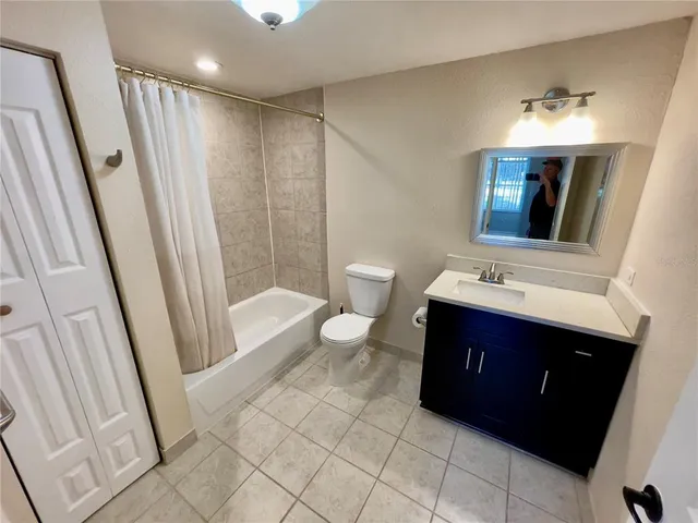 a bathroom with a sink vanity granite tub and a mirror