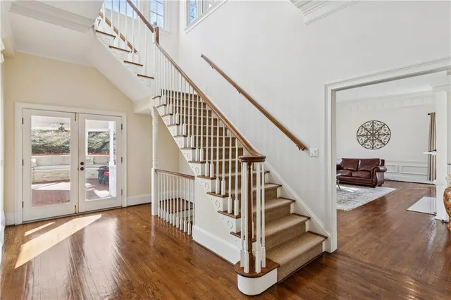 a view of entryway and hall with wooden floor