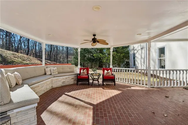 a view of a house with wooden fence and large windows