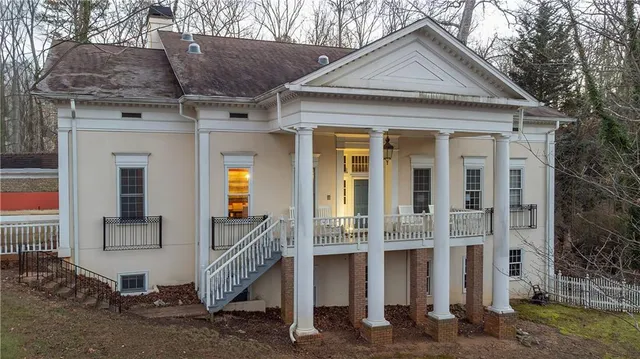a patio with a table and chairs under an umbrella