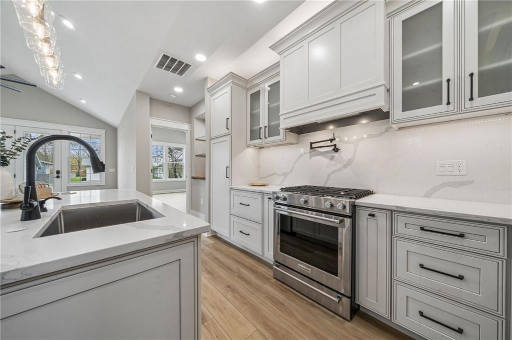 224 Bunger Street Ligonier, PA 15658 - Photo 17 of 50 a kitchen with stainless steel appliances granite countertop a sink dishwasher a stove and a refrigerator with wooden cabinets