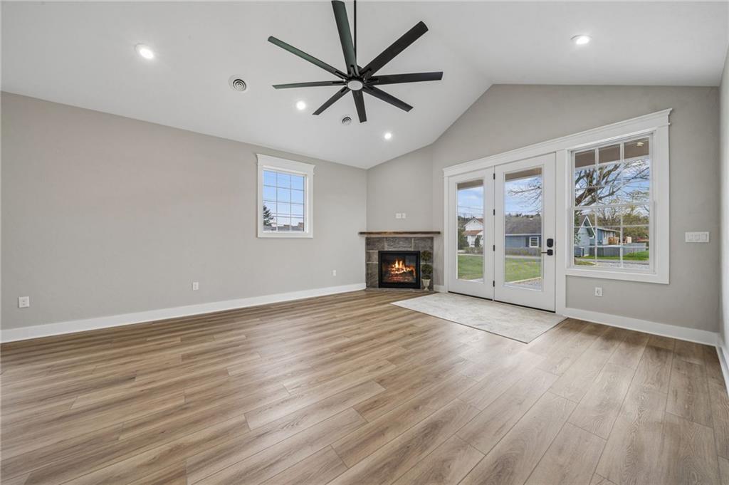224 Bunger Street Ligonier, PA 15658 - Photo 20 of 50 an empty room with windows a fireplace a ceiling fan and wooden floor