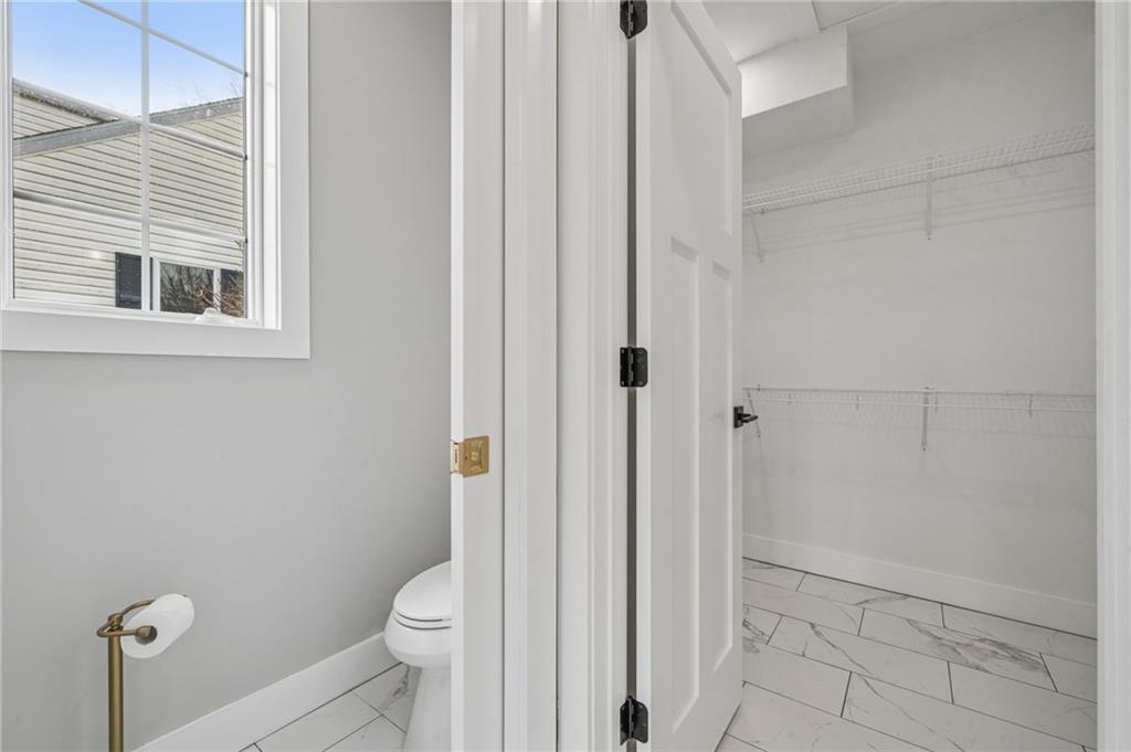 224 Bunger Street Ligonier, PA 15658 - Photo 29 of 50 a bathroom with a granite countertop toilet and a shower